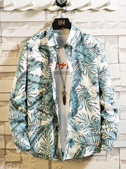 Front view of a white shirt with blue-green tropical leaf print