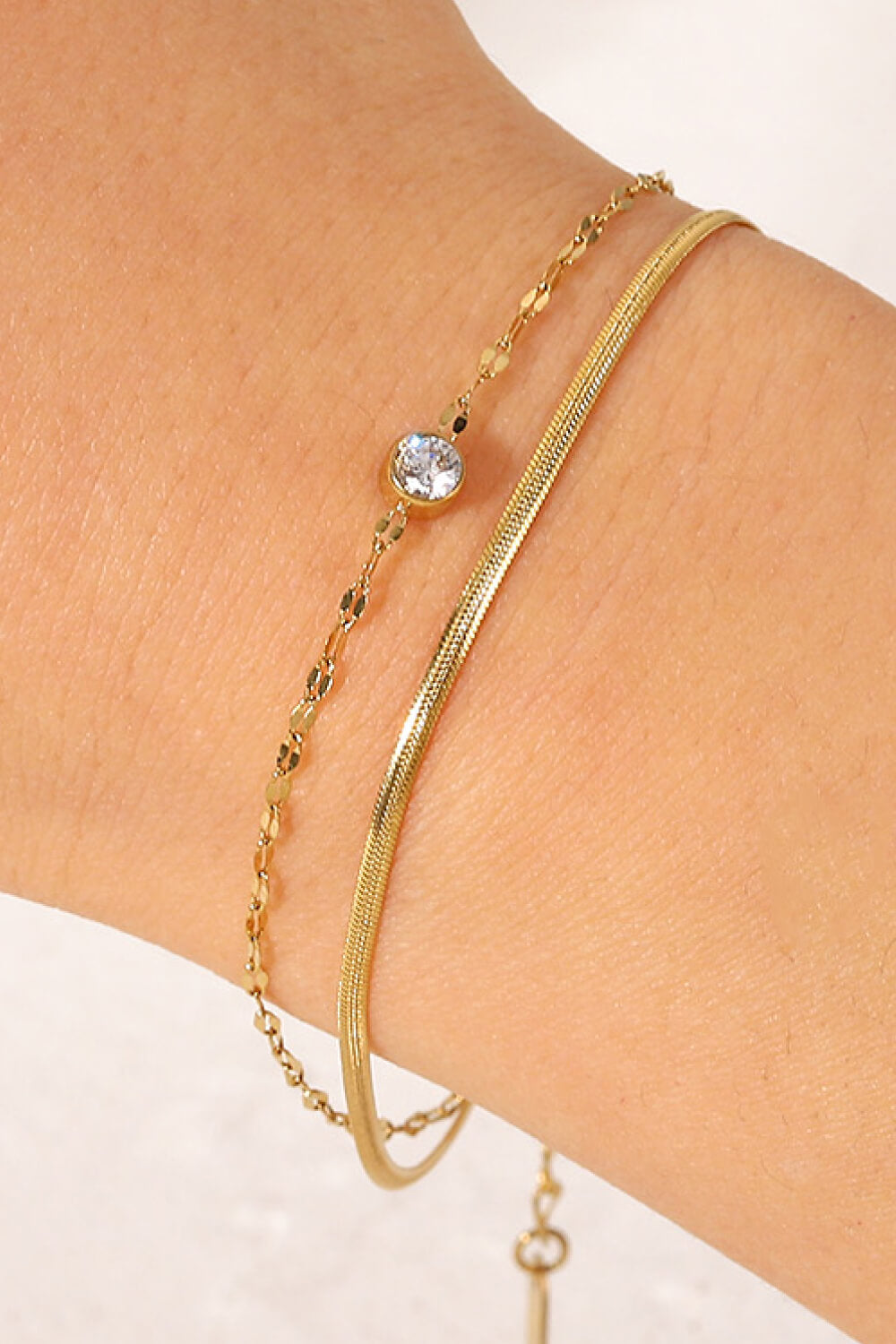 Gold-tone double-layer rhinestone bracelet shown from a side angle