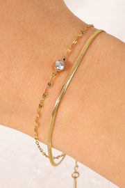 Gold-tone double-layer rhinestone bracelet shown from a side angle