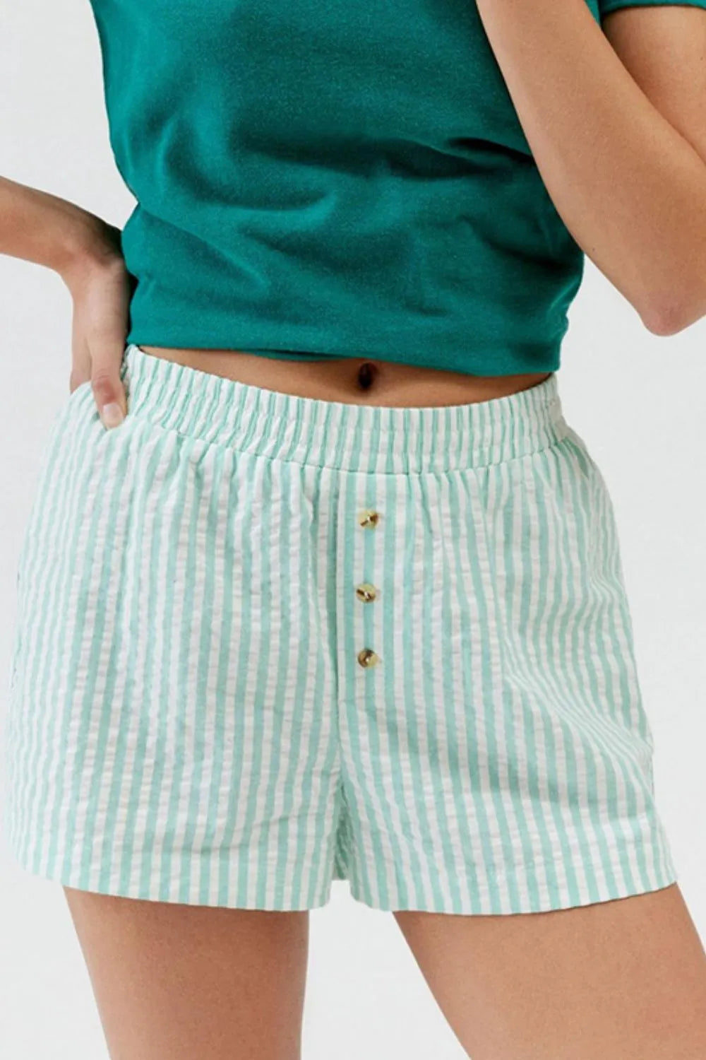 Mint green striped elastic-waist shorts, front view with buttons