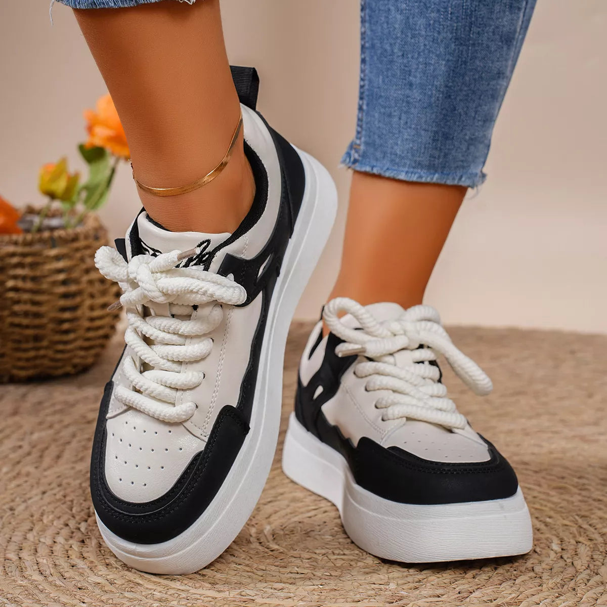 Black and white platform sneakers worn with jeans