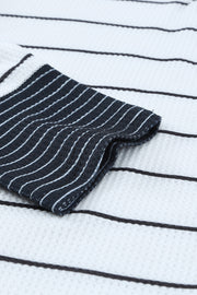 Close-up of striped waffle-knit fabric and dark cuff