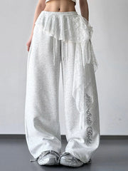 Front view of gray wide-leg pants with lace detail and script