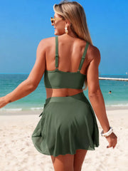 Model wearing a green V-neck bikini with wrap skirt