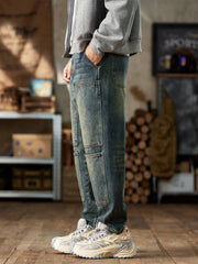 Side view of blue vintage-wash jeans showing stitched front panels