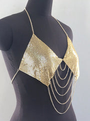 Gold chainmail halter top on mannequin, angled view