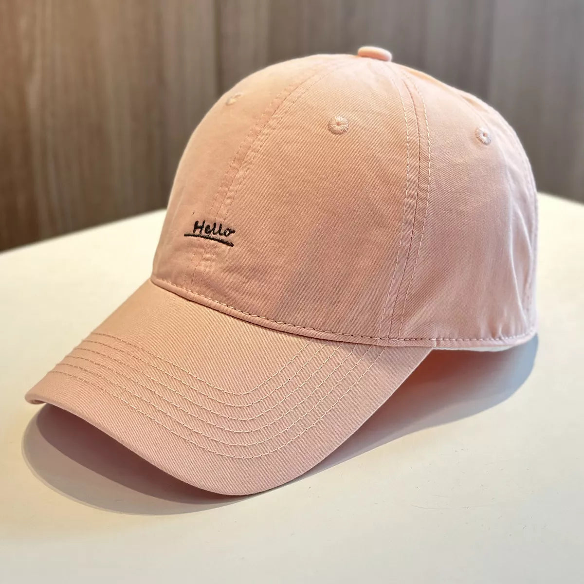 Pink cotton baseball cap with small Hello embroidery on front