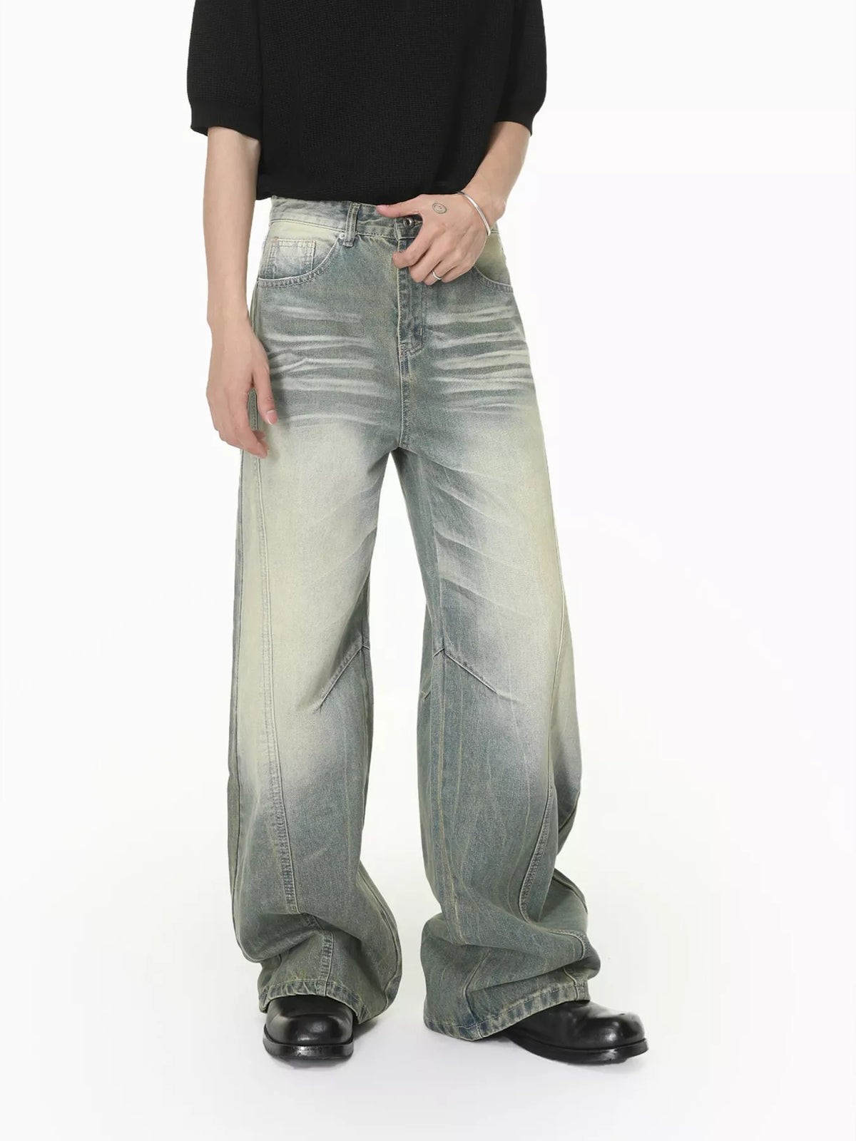 Angled front view of light-wash wide-leg jeans with faded thighs