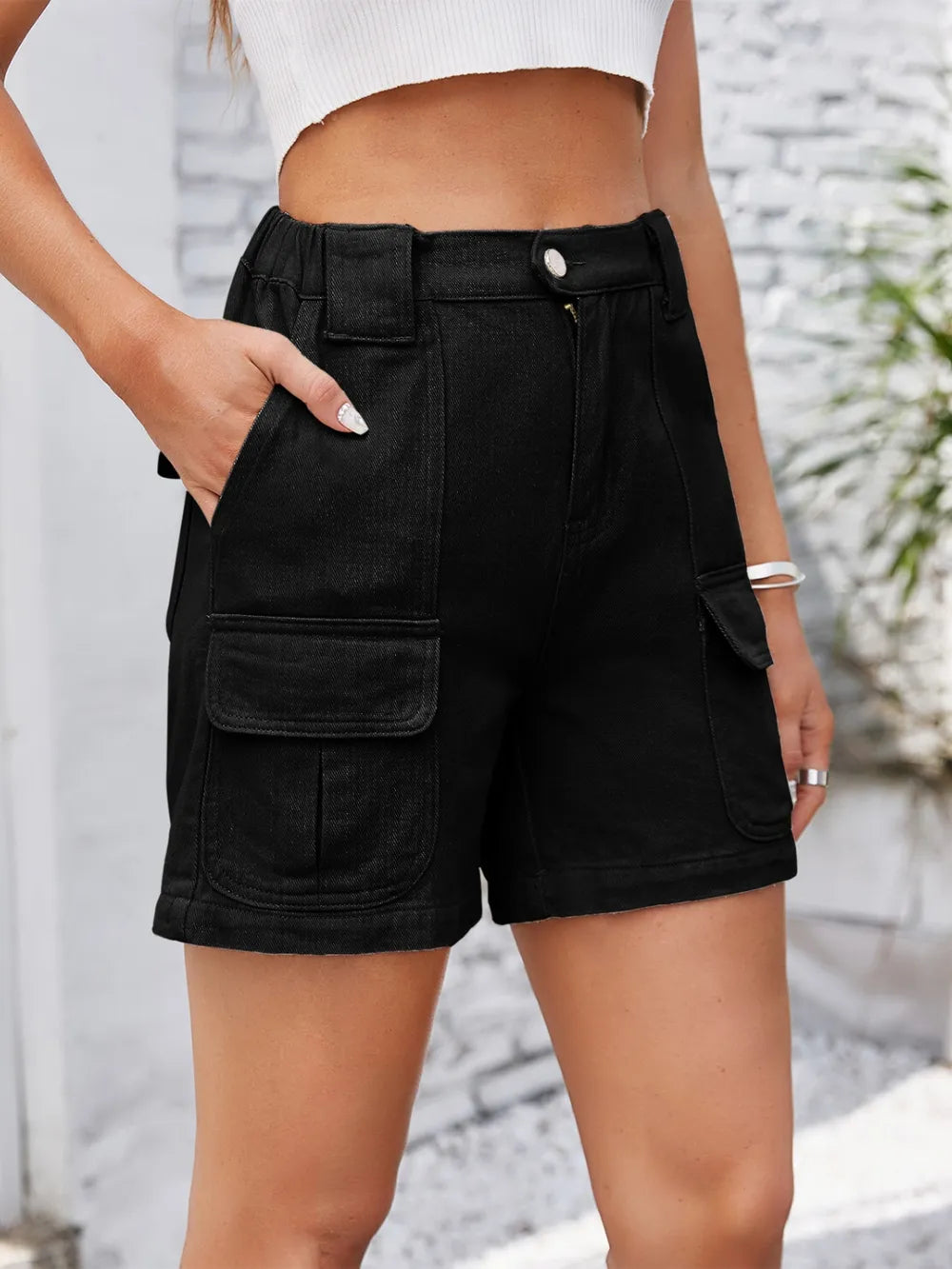 Front view of black washed denim cargo shorts with large pockets.