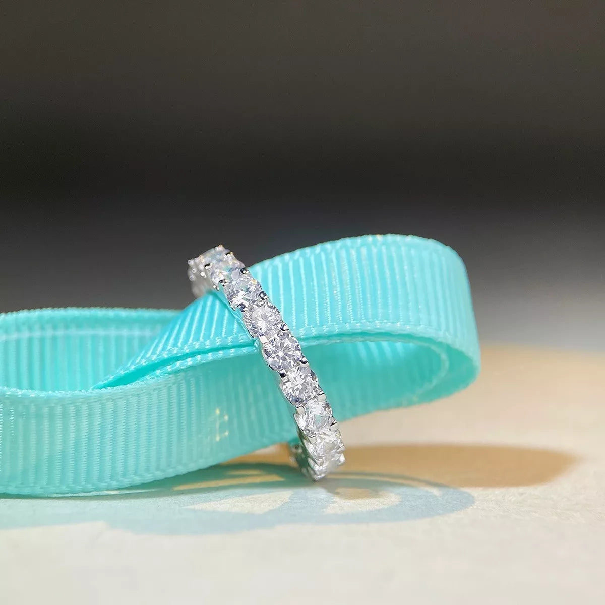 Silver ring with a large pale pink oval-cut center stone and small shoulder stones, front view.