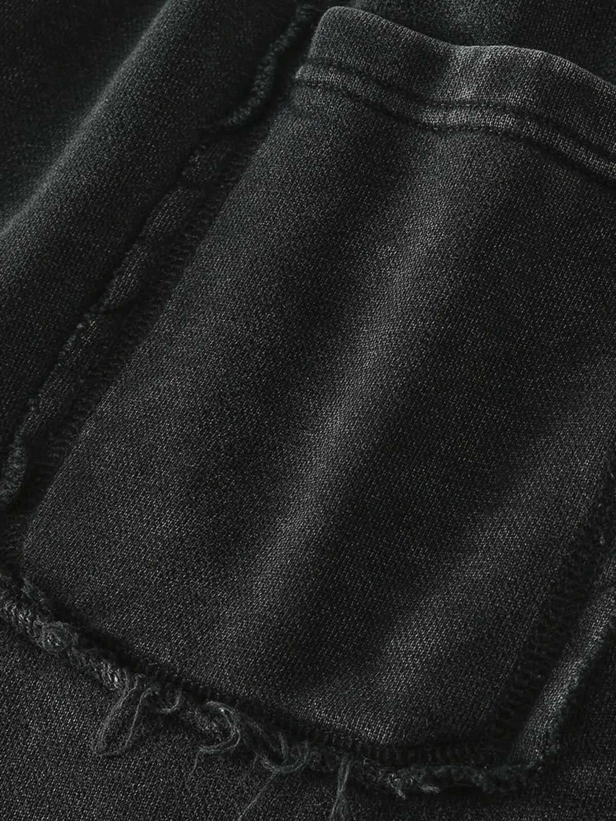 Close-up of a pocket seam on the black shorts