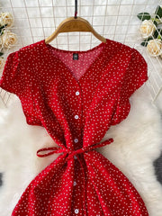 Red dress detail showing V-neck, buttons and tie waist