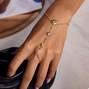 Gold sun charm bracelet displayed on a white surface