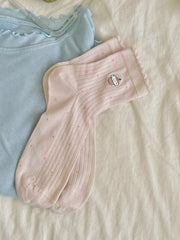 Pair of breathable knit crew socks laid flat