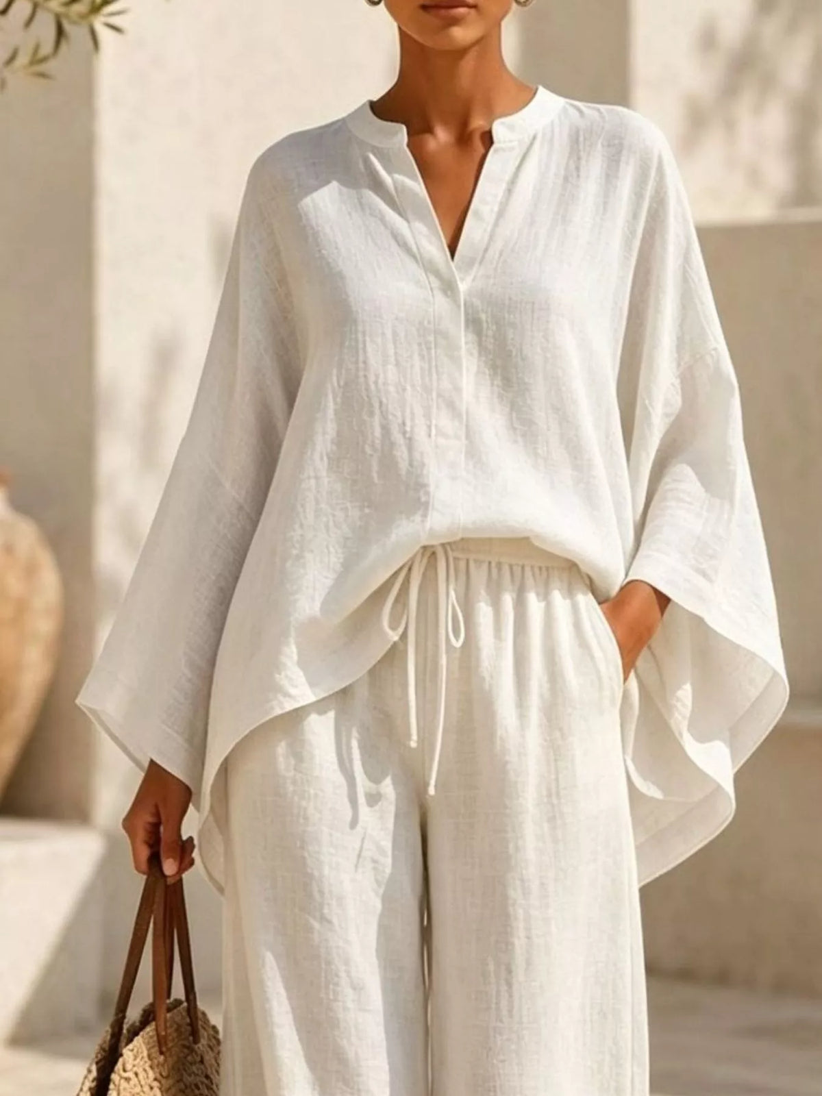 Closer front view of the ivory set highlighting its loose top and tied waist.