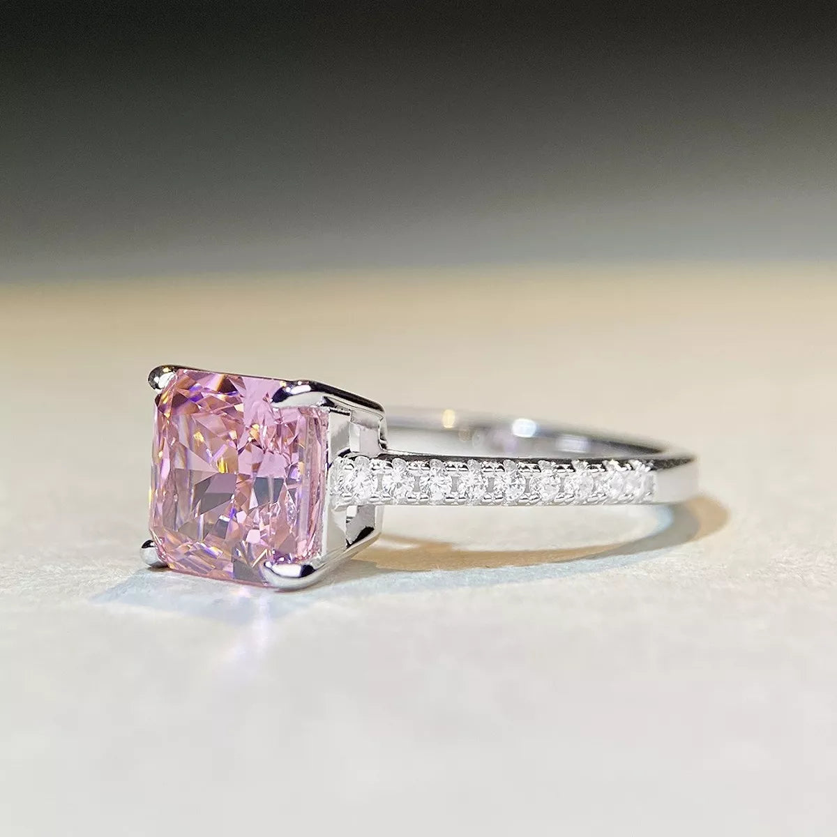 Side view of square pink stone ring