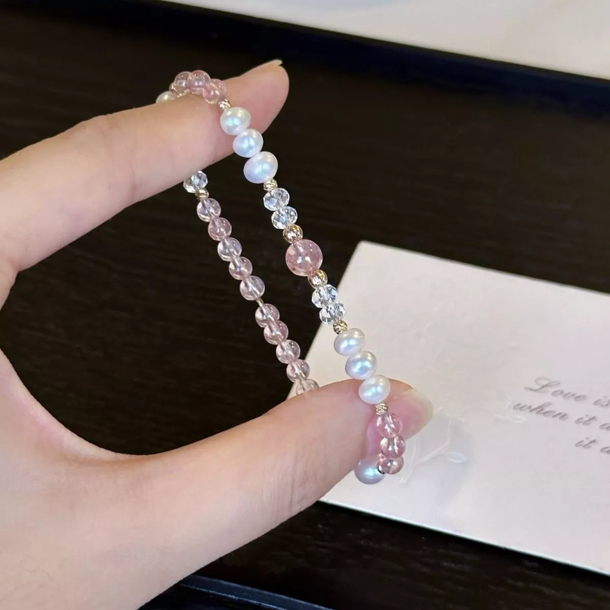 Close view of pearl and crystal beads on a wrist