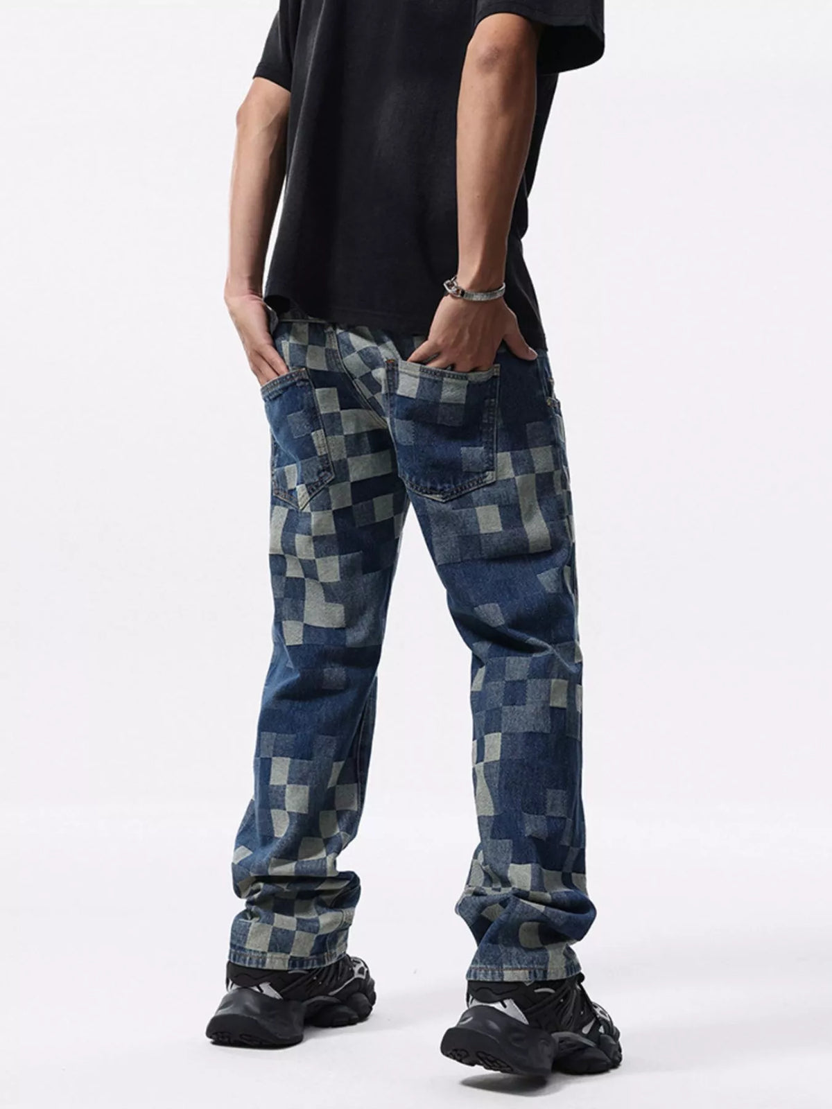 Rear angled view of blue checkerboard jeans showing two patch pockets