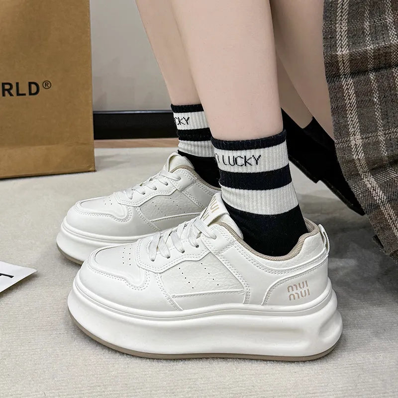 White platform sneakers worn with striped socks