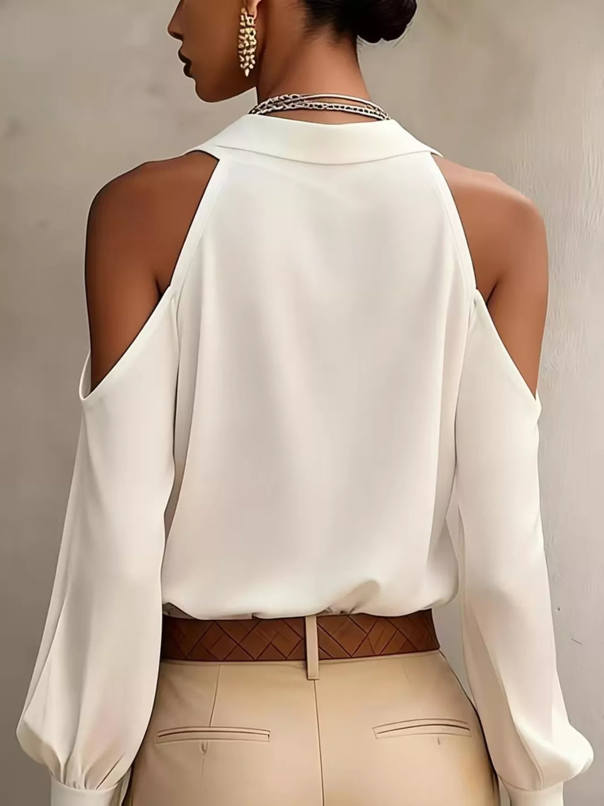 Back view of white cold-shoulder top with open shoulder panels.