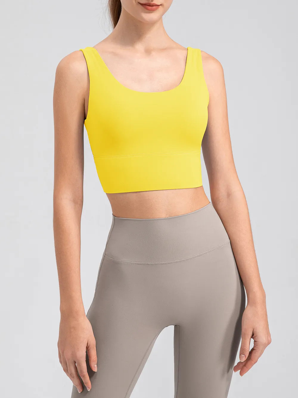Yellow cropped tank shown from the front with leggings