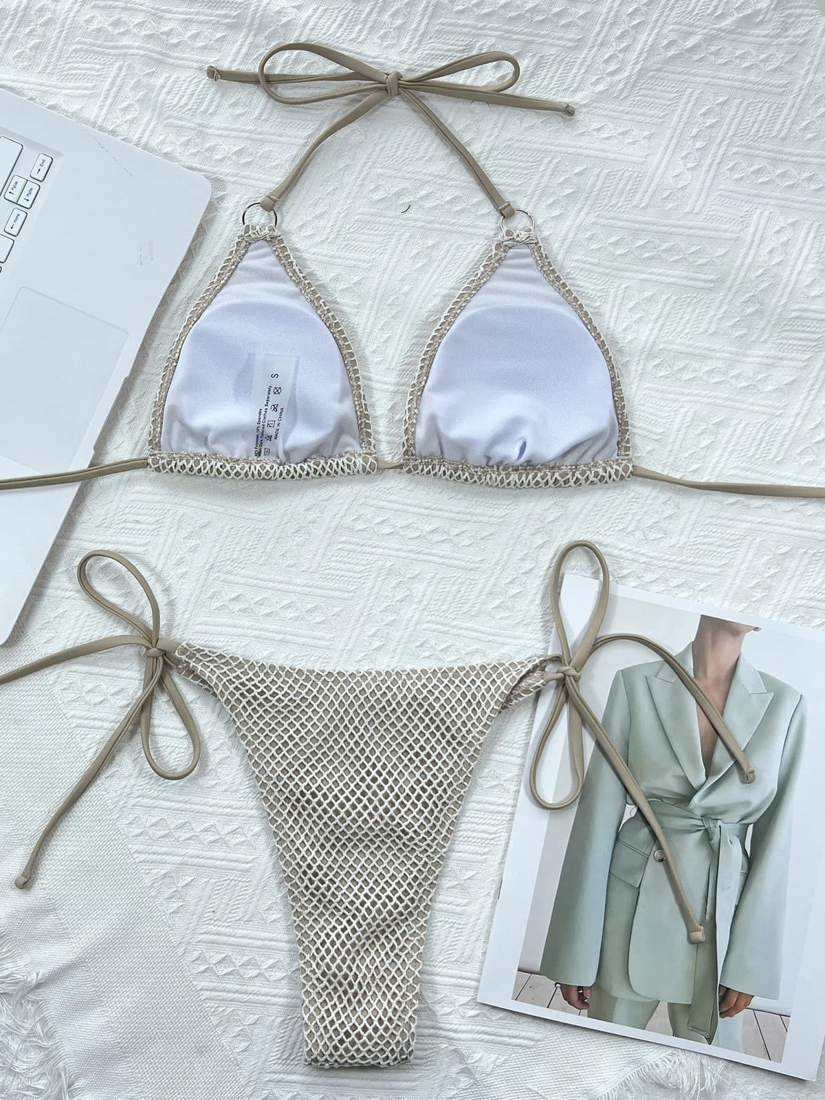 Cream fishnet bikini laid flat showing white cup lining and matching bottoms