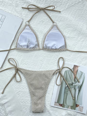 Cream fishnet bikini laid flat showing white cup lining and matching bottoms