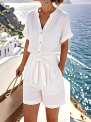 Front view of the white button-front shirt and shorts set on a model.