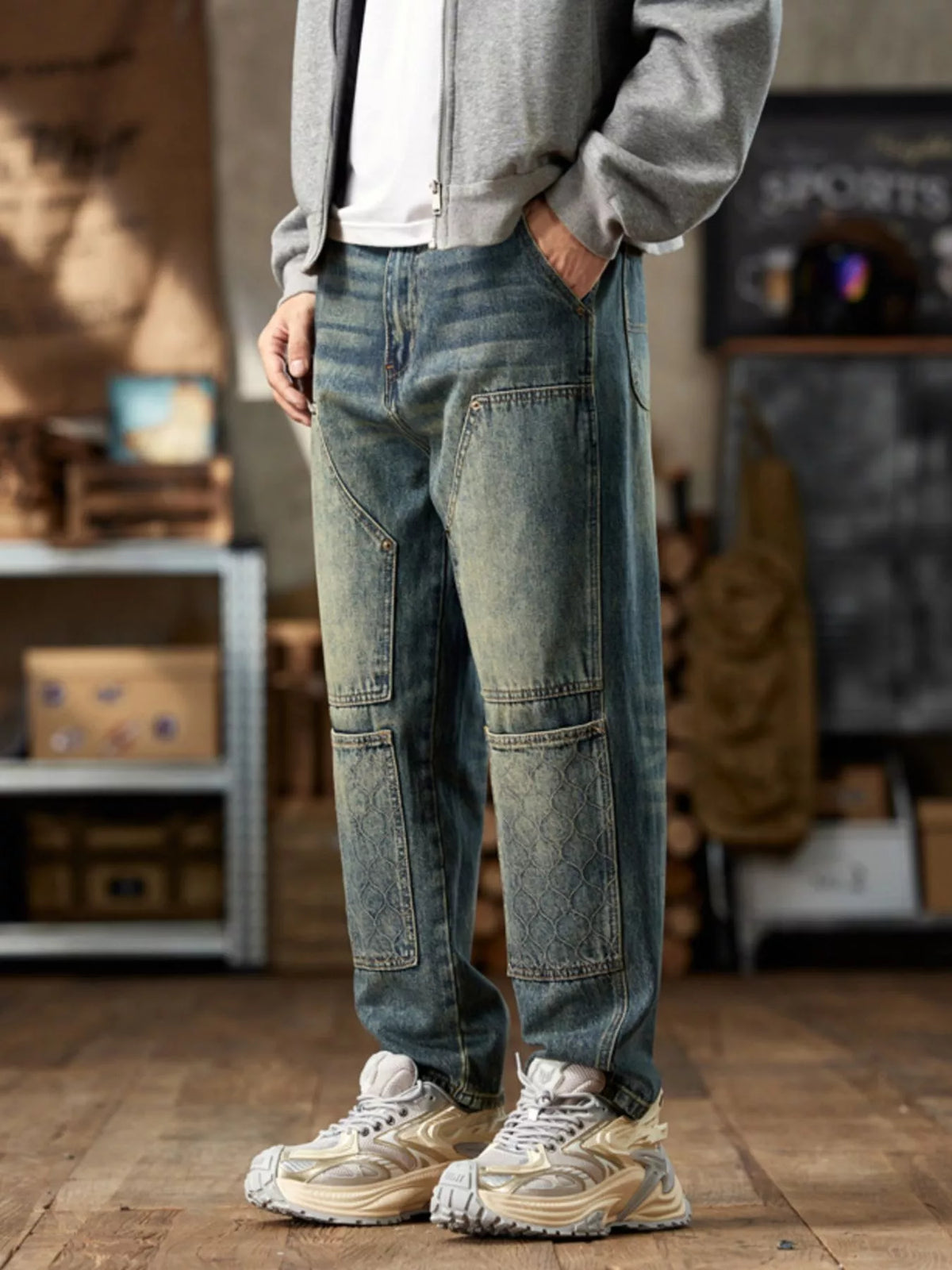 Angled front view of blue straight-leg jeans with faded panel details
