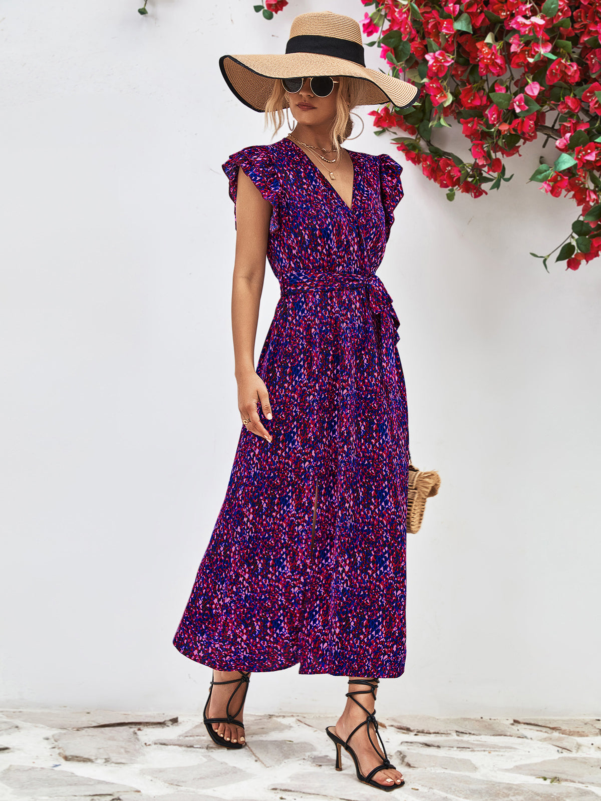 Front view of purple printed dress with V-neck, flutter sleeves and long straight skirt.