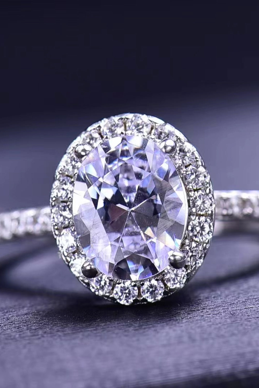 Platinum-plated oval moissanite ring shown from the side