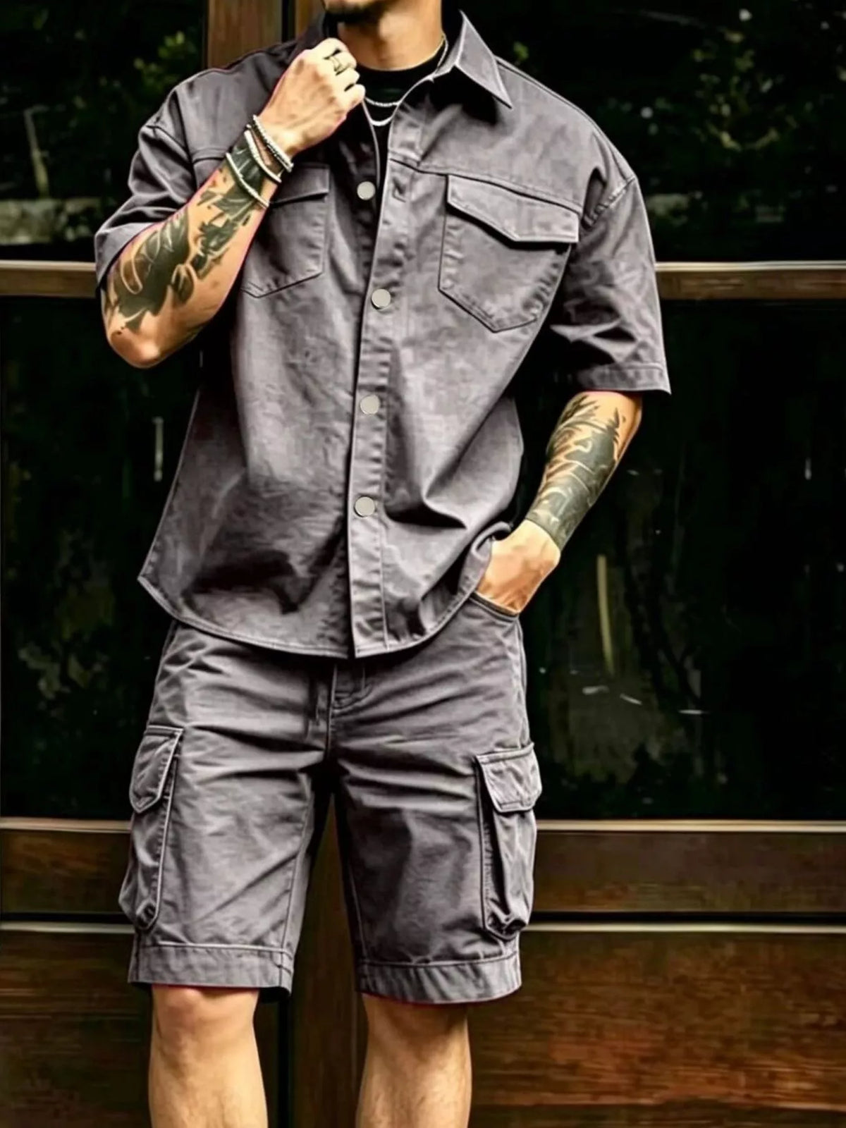 Model wearing gray cargo shirt and matching shorts with side cargo pockets
