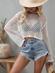 Close view of the white openwork cropped cover-up and flared sleeves.