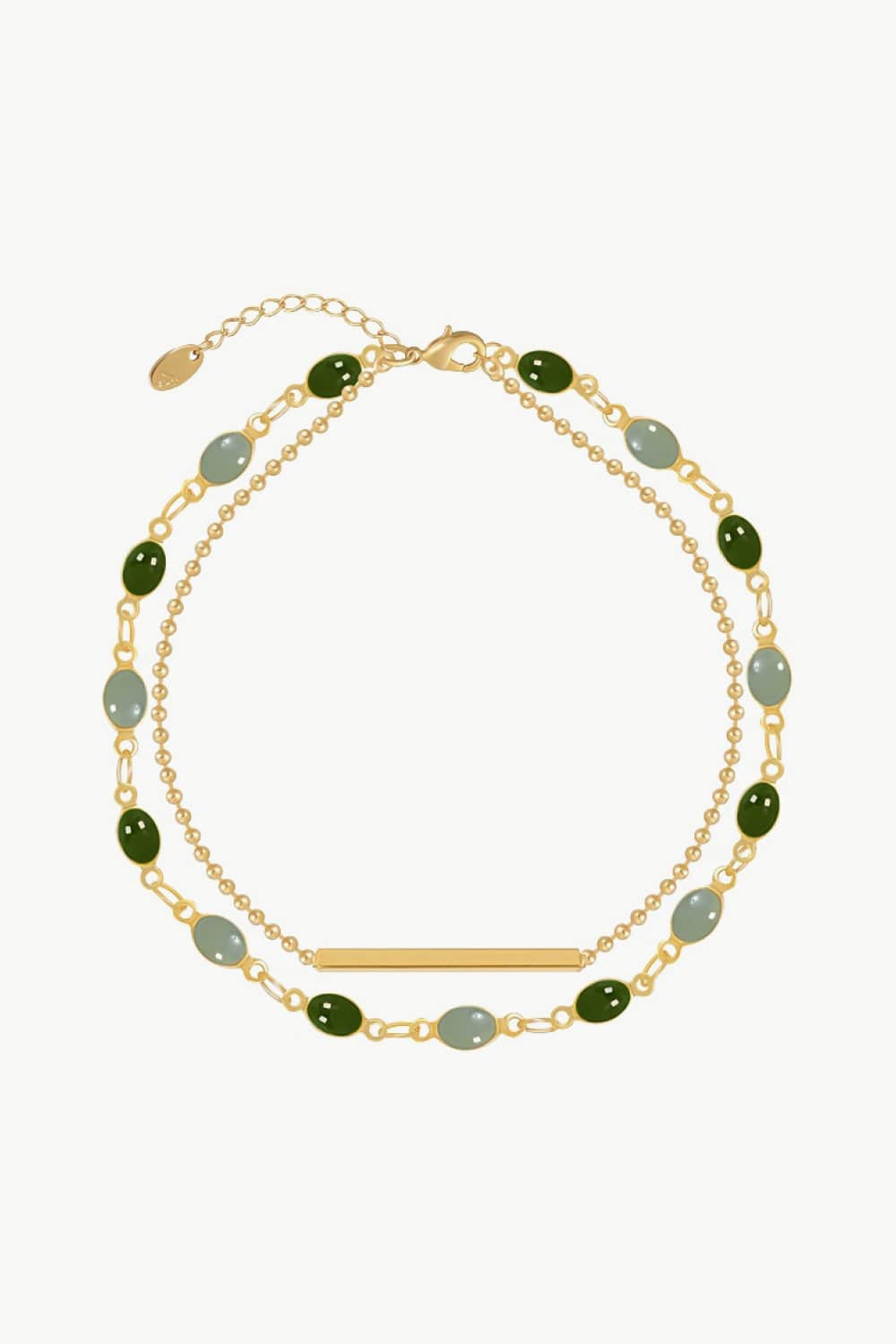 Gold-tone double-layer bracelet with green and pale blue oval stones, chain links and a slim bar