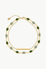 Gold-tone double-layer bracelet with green and pale blue oval stones, chain links and a slim bar