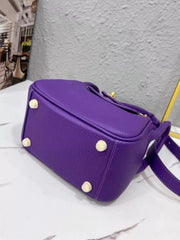 Underside of the purple crossbody bag with four protective feet