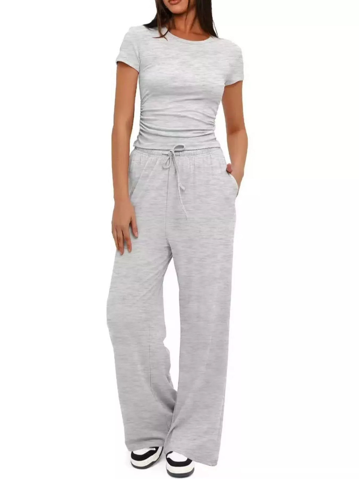 Front view of a model wearing the white ribbed tank and wide-leg pants set.