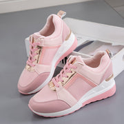 Pink wedge sneakers displayed as a pair