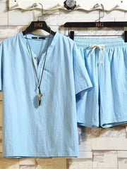 Light blue short-sleeve button-front shirt and matching drawstring shorts on hangers