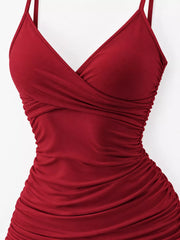 Close view of the burgundy dress's crossover neckline and gathered waist.