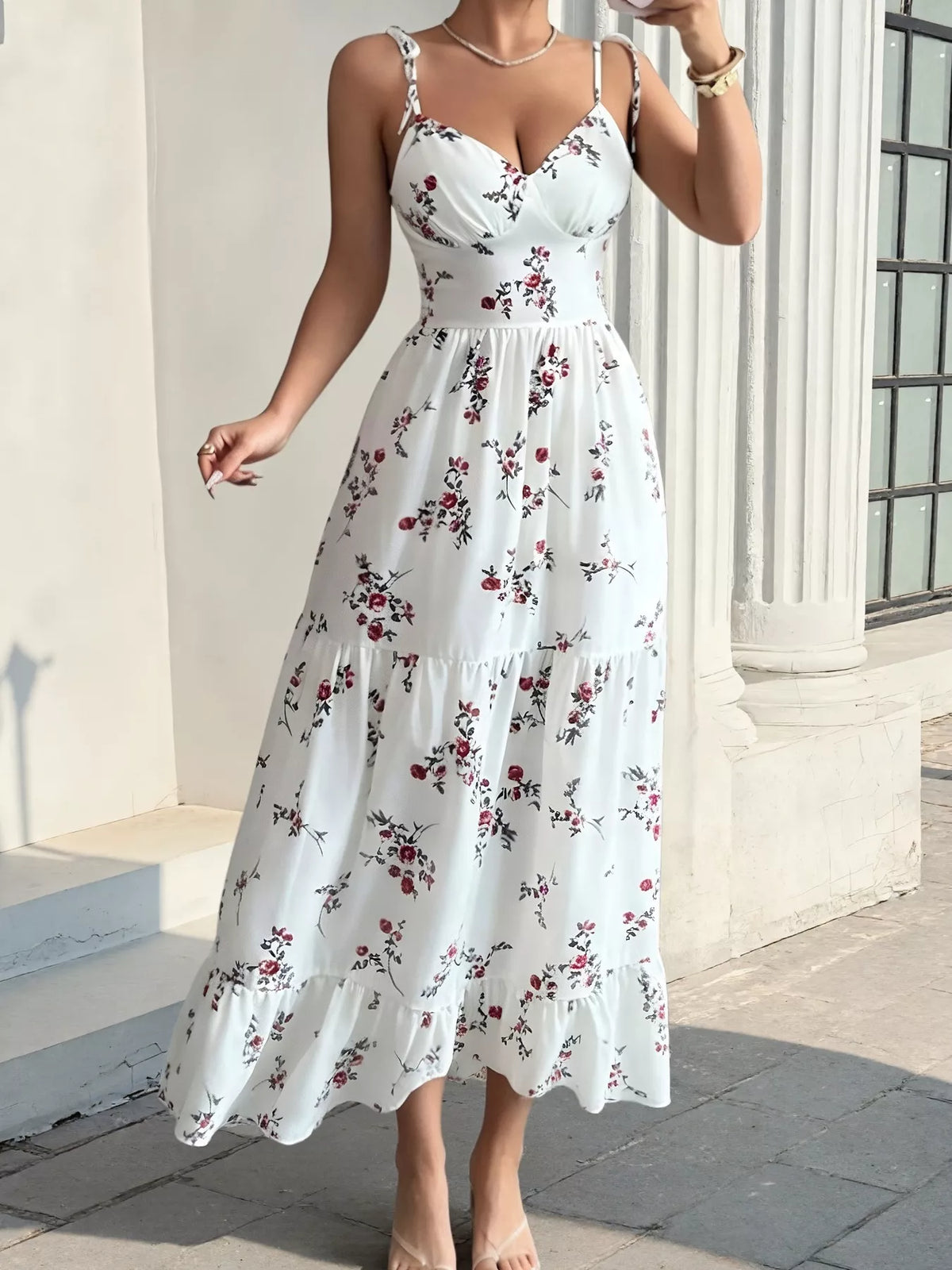 White floral spaghetti-strap tiered midi dress shown from the front
