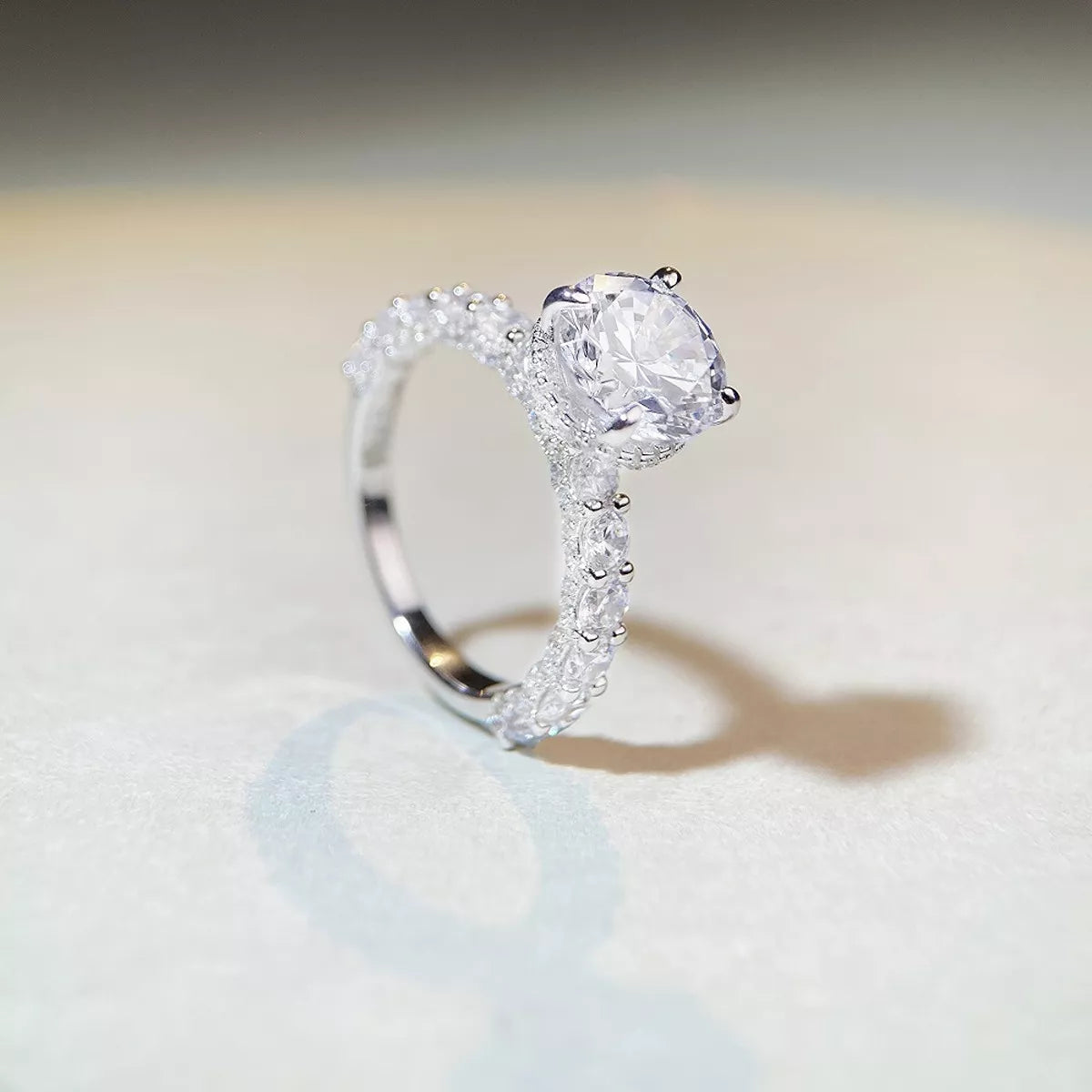 Upright side view of the ring showing the center stone above the band.
