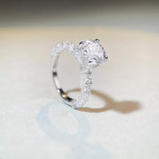 Upright side view of the ring showing the center stone above the band.
