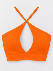 Back view of orange halter crop cami with thin crossed straps
