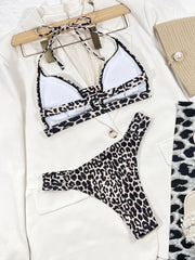 Leopard-print bikini top with white cup lining and matching bottoms laid flat