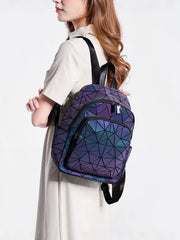 Model wearing geometric purple-blue backpack, side view