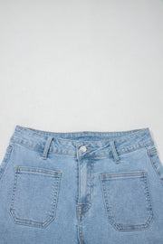 Close-up of back patch pockets on light-blue denim shorts