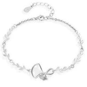 Silver ginkgo leaf bracelet with delicate leaf links displayed on white