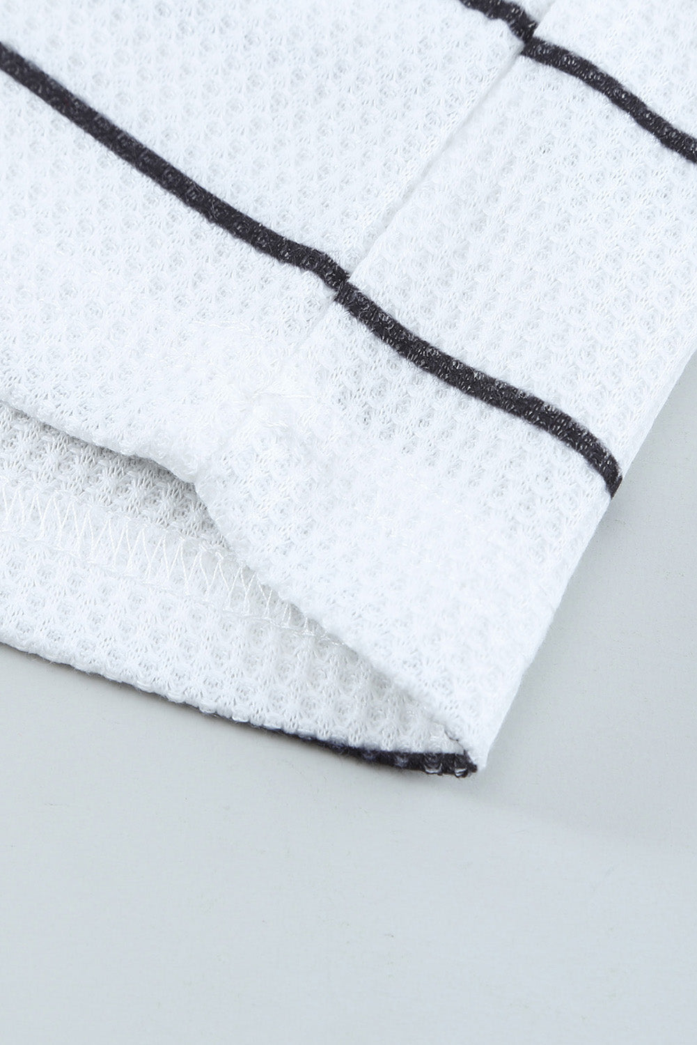 Close-up of waffle-knit texture on white fabric