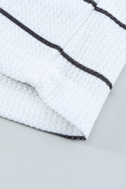 Close-up of waffle-knit texture on white fabric